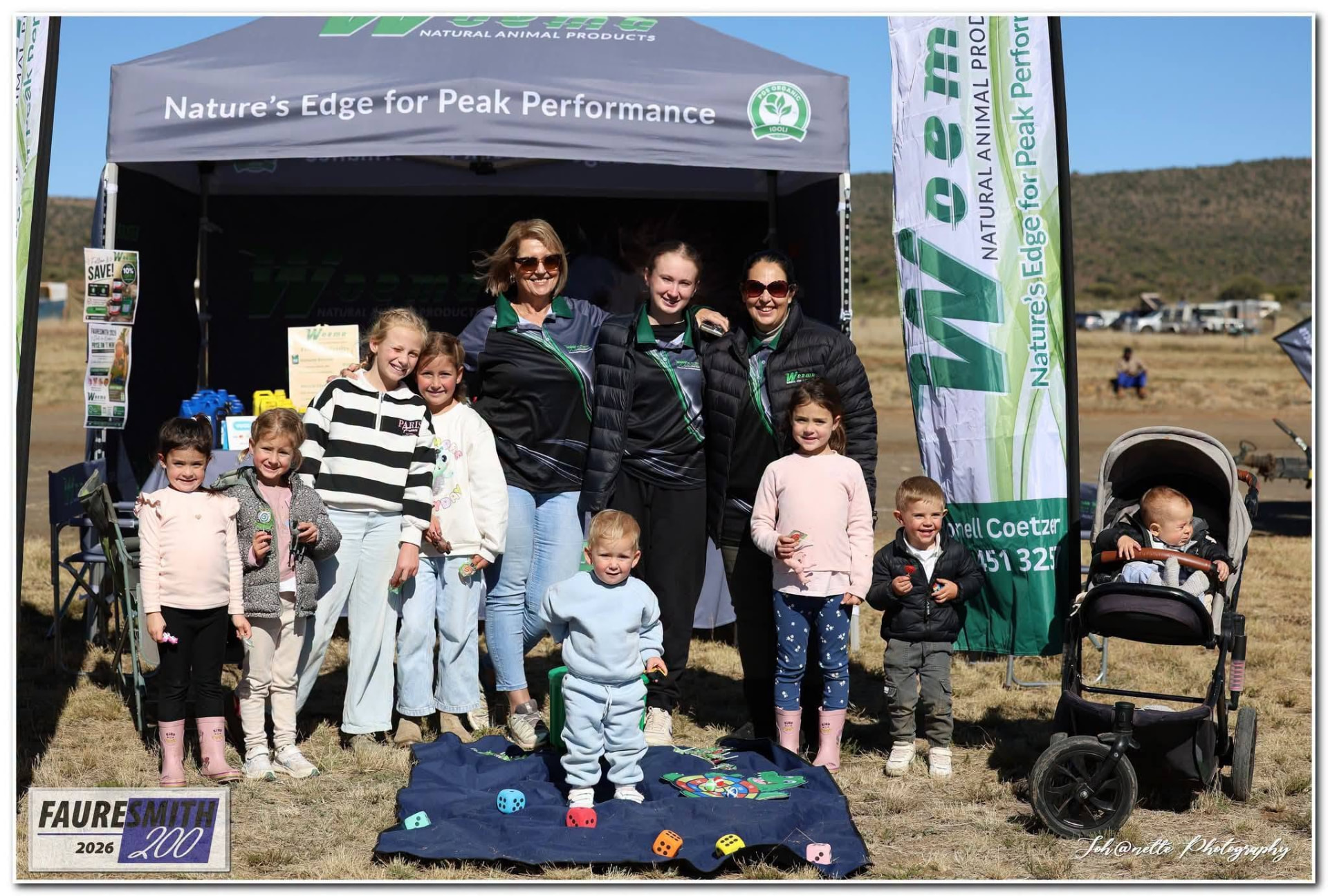 Families and children posing in front of the WOEMA banner at Fauresmith 2026